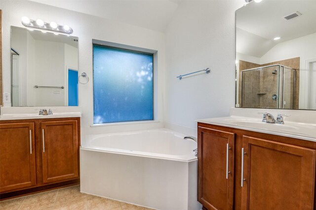 bathroom featuring visible vents, two vanities, a garden tub, and a stall shower