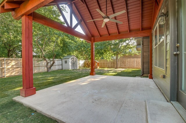 view of patio / terrace featuring a fenced backyard, a storage unit, an outbuilding, and a ceiling fan