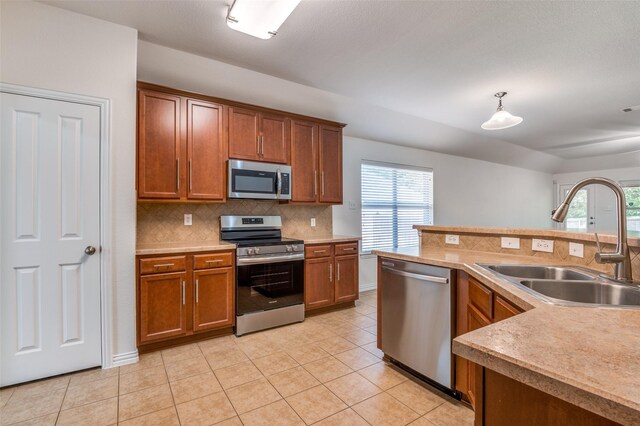 kitchen with a sink, plenty of natural light, backsplash, and stainless steel appliances