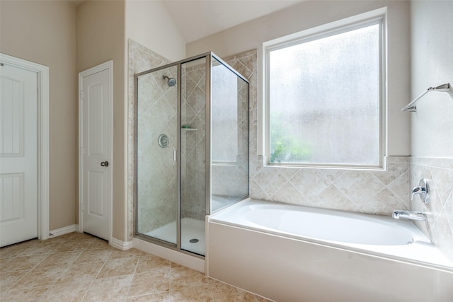 full bath featuring tile patterned flooring, a shower stall, and a garden tub