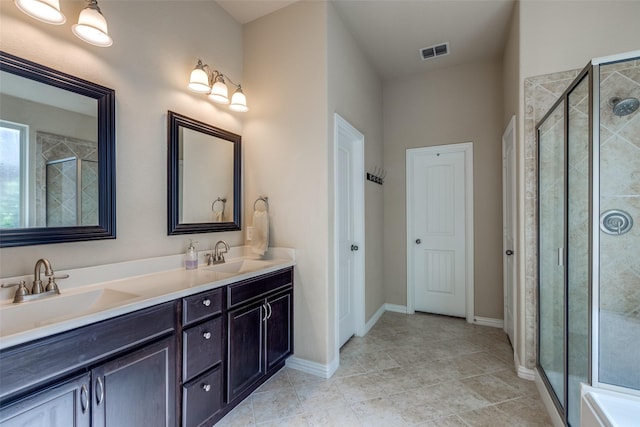 bathroom with visible vents, a shower stall, and a sink