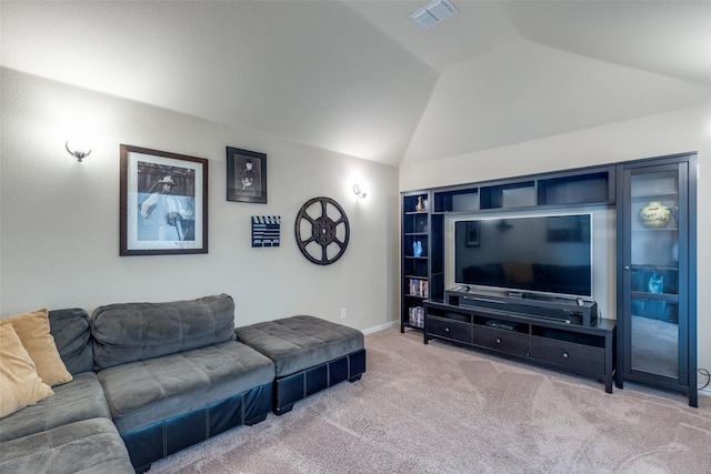 carpeted living room featuring baseboards, lofted ceiling, built in shelves, and visible vents