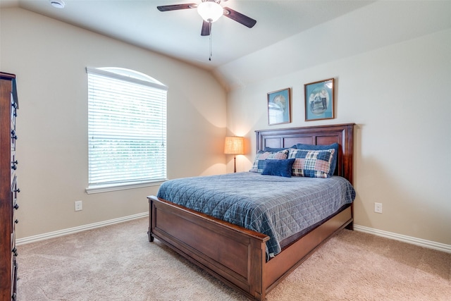 bedroom featuring a ceiling fan, baseboards, light carpet, and lofted ceiling