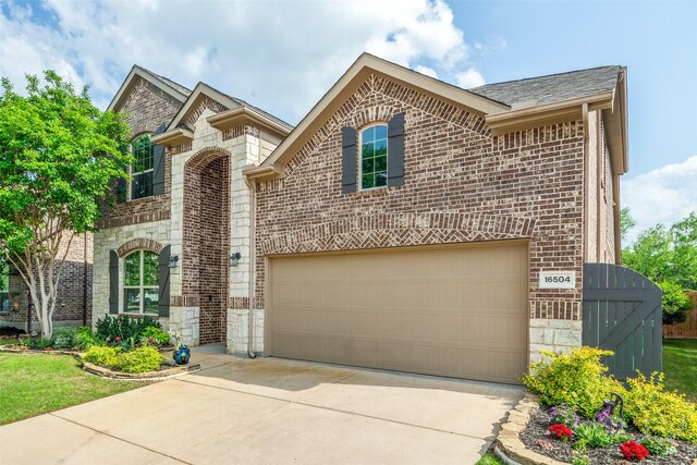 view of front facade featuring brick siding, a gate, stone siding, and concrete driveway