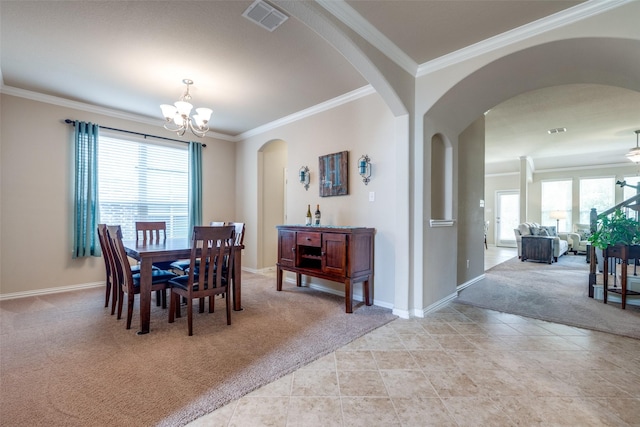dining space with visible vents, ornamental molding, a healthy amount of sunlight, and light carpet