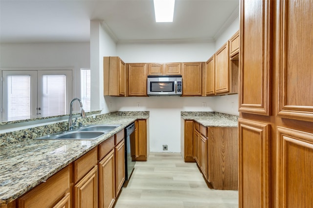 2372 Homewood Ln, Grand Prairie, TX 75050 - kitchen with stainless steel microwave, a sink, dishwasher, brown cabinetry, and light stone counters