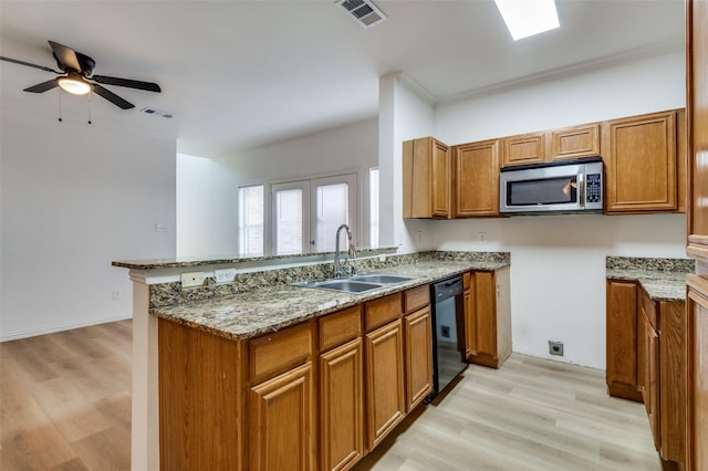 2372 Homewood Ln, Grand Prairie, TX 75050 - kitchen featuring stainless steel microwave, a sink, brown cabinets, and crown molding