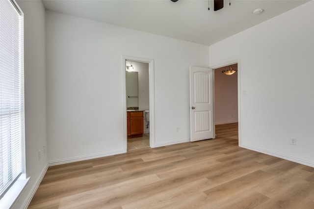 2372 Homewood Ln, Grand Prairie, TX 75050 - unfurnished bedroom with light wood-type flooring, baseboards, ensuite bathroom, and ceiling fan