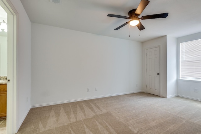 2372 Homewood Ln, Grand Prairie, TX 75050 - spare room with light colored carpet, a ceiling fan, and baseboards
