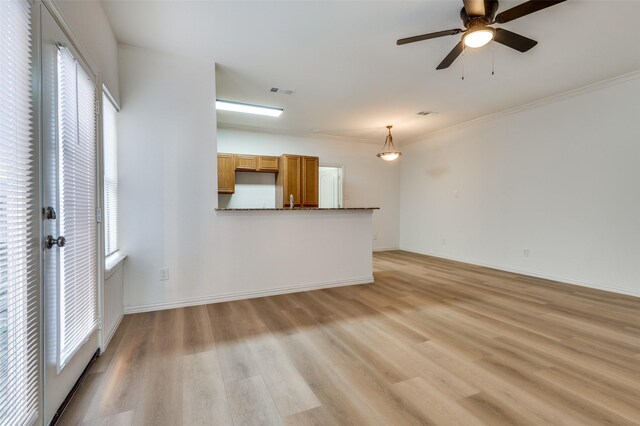 2372 Homewood Ln, Grand Prairie, TX 75050 - unfurnished living room featuring light wood-type flooring, a ceiling fan, ornamental molding, and baseboards