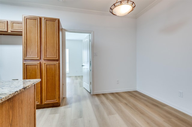 2372 Homewood Ln, Grand Prairie, TX 75050 - unfurnished dining area with light wood-style flooring, ornamental molding, and baseboards