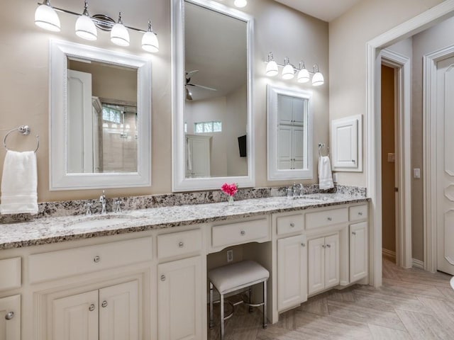 full bath with a ceiling fan and double vanity