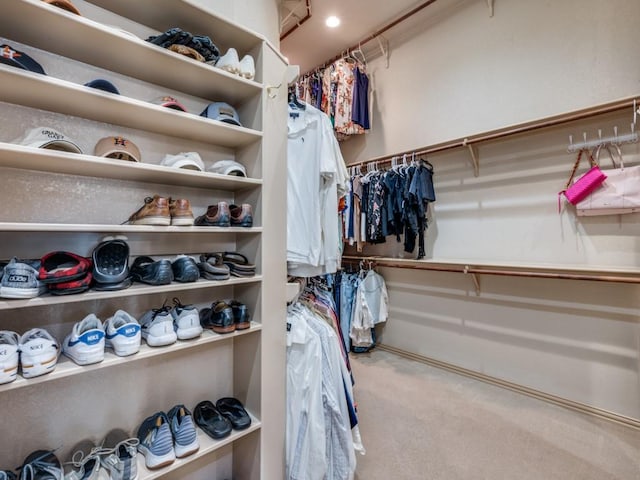 walk in closet with carpet flooring