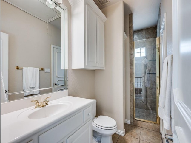 full bathroom featuring toilet, a shower stall, tile patterned floors, and vanity