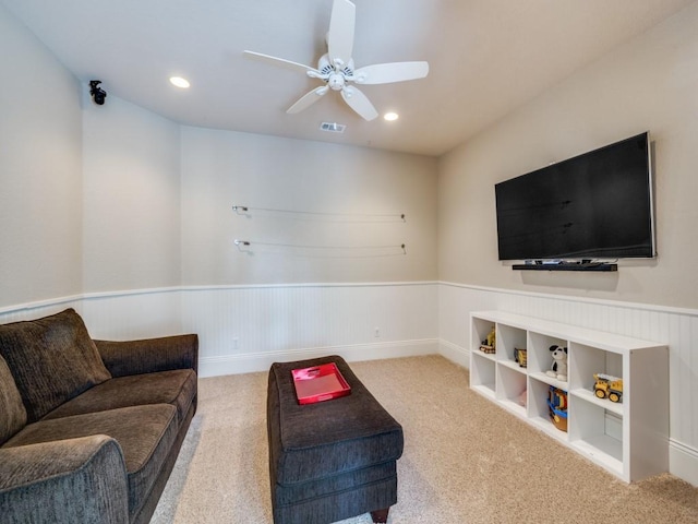living room featuring a wainscoted wall, carpet flooring, ceiling fan, and recessed lighting
