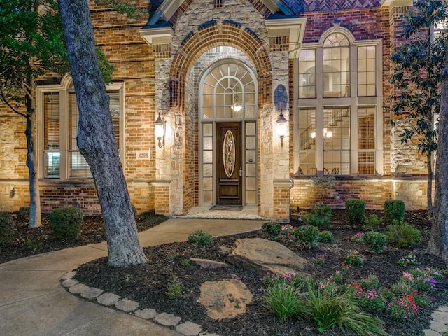 property entrance featuring brick siding