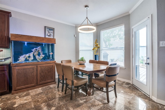 dining area with crown molding and baseboards