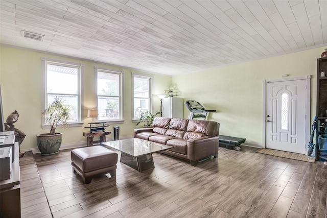 living area featuring visible vents, a healthy amount of sunlight, and wood finished floors
