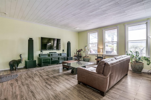 living area with wood ceiling, ornamental molding, wood finished floors, and a wealth of natural light