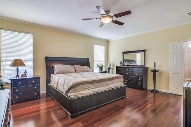 bedroom featuring visible vents, ornamental molding, baseboards, dark wood-style floors, and a ceiling fan