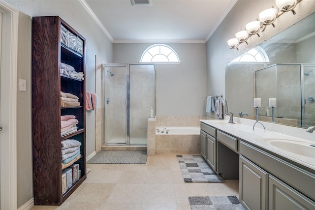 bathroom with a sink, double vanity, a stall shower, and a garden tub