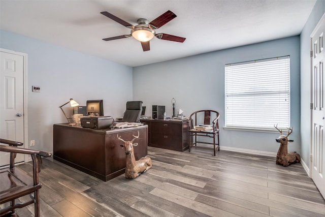 office area featuring baseboards, ceiling fan, and wood-type flooring