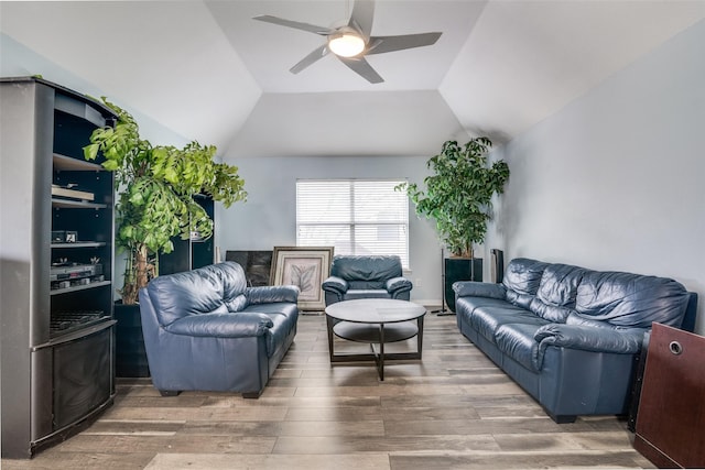living room featuring ceiling fan, wood finished floors, and lofted ceiling