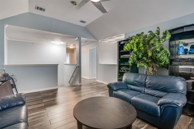 living room with a ceiling fan, lofted ceiling, wood finished floors, and visible vents