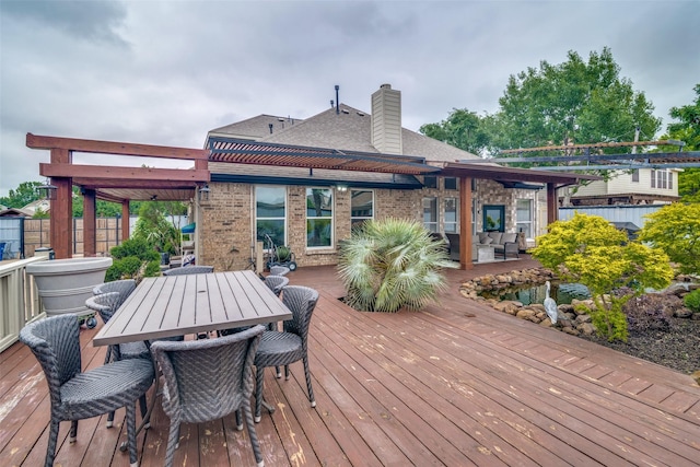 wooden deck with outdoor dining area and fence
