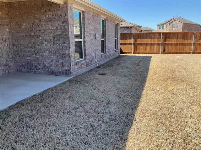 view of yard featuring fence and a patio area