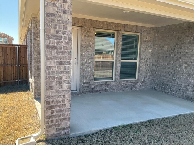 view of patio / terrace featuring fence