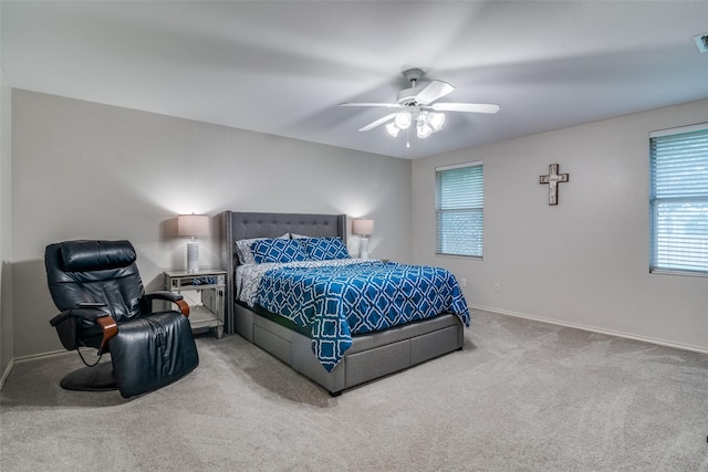 bedroom with baseboards, a ceiling fan, carpet, and multiple windows