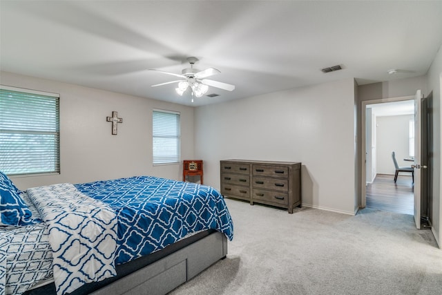 bedroom featuring carpet floors, ceiling fan, baseboards, and visible vents