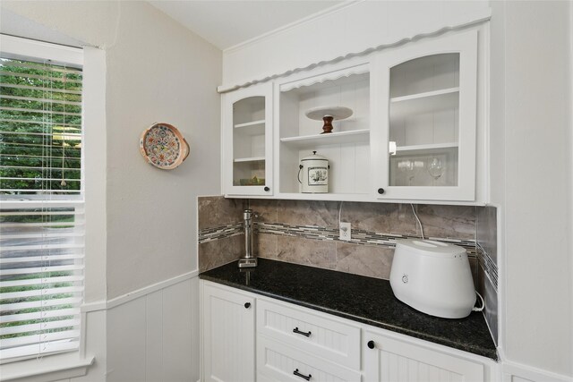 bar featuring a wainscoted wall and backsplash