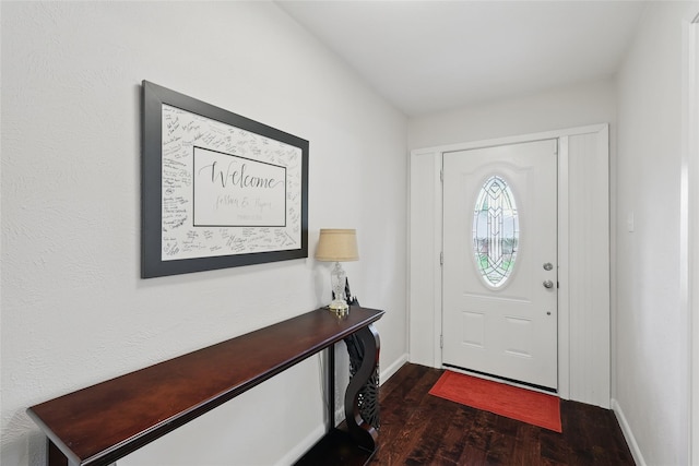 entryway featuring baseboards and dark wood-type flooring