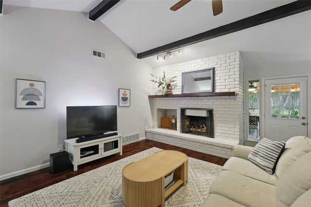 living room with a brick fireplace, baseboards, visible vents, and ceiling fan