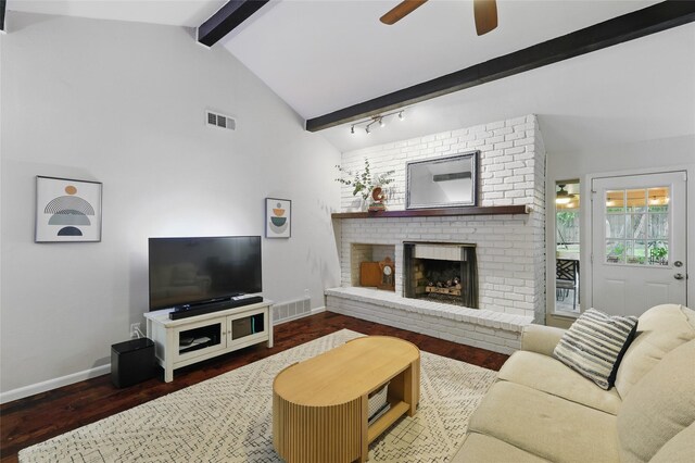 living area featuring visible vents, baseboards, a brick fireplace, and ceiling fan