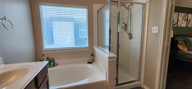 full bathroom featuring vanity, a textured wall, a stall shower, and a bath