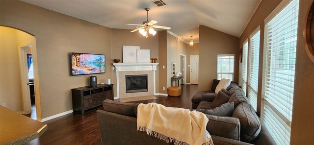 living room featuring arched walkways, ceiling fan, dark wood-type flooring, and visible vents