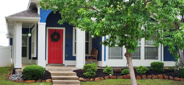 entrance to property with a shingled roof