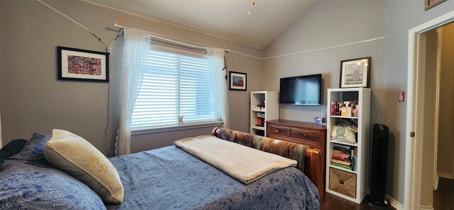 bedroom featuring baseboards, vaulted ceiling, and dark wood-style floors