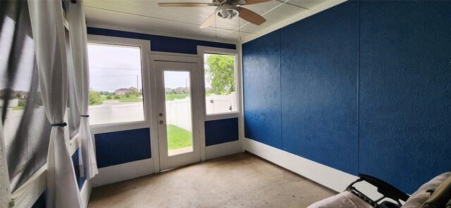 entryway featuring carpet, a textured wall, and ceiling fan