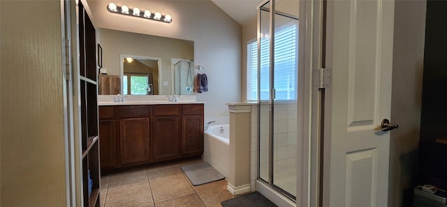 bathroom featuring double vanity, a bath, tile patterned floors, a stall shower, and vaulted ceiling