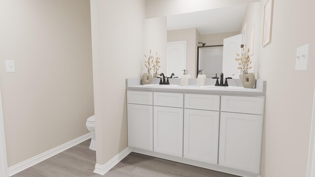 full bathroom with double vanity, a sink, and wood finished floors