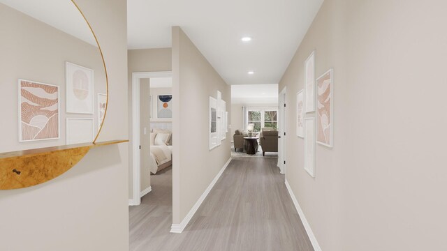 hallway featuring light wood-style floors, recessed lighting, and baseboards