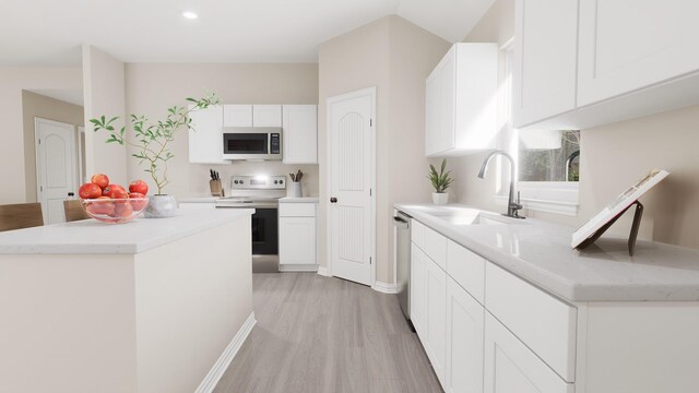 kitchen featuring a sink, appliances with stainless steel finishes, light wood-style flooring, and white cabinetry