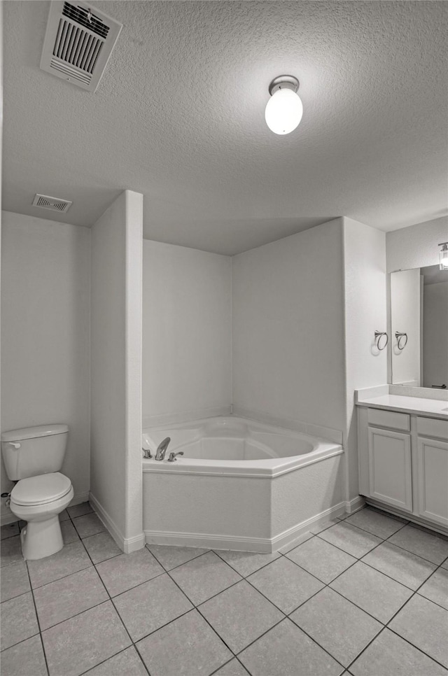 604 Hidden Dale Dr, Fort Worth, TX 76140 - full bathroom with tile patterned floors, vanity, a garden tub, a textured ceiling, and toilet