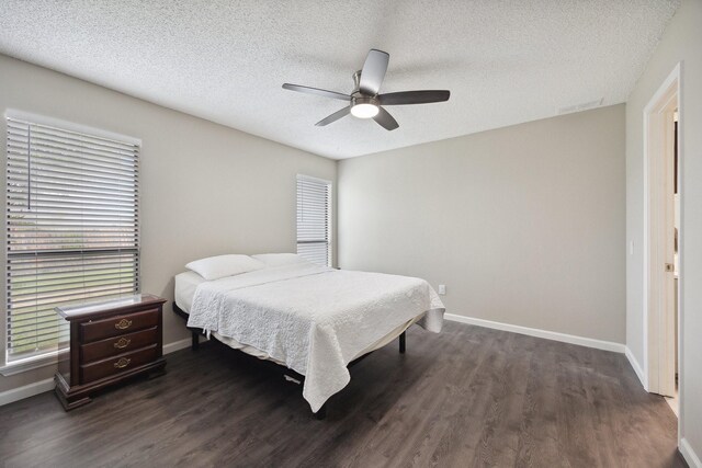 1706 Delaford Cir, Carrollton, TX 75007 - bedroom with baseboards, ceiling fan, dark wood-style flooring, and a textured ceiling