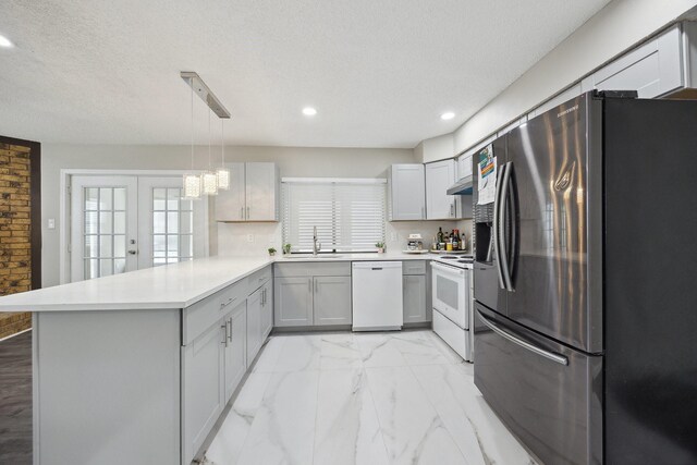 1706 Delaford Cir, Carrollton, TX 75007 - kitchen featuring a sink, white appliances, gray cabinets, a peninsula, and recessed lighting