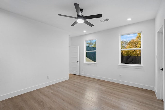 spare room featuring visible vents, baseboards, light wood-type flooring, recessed lighting, and a ceiling fan